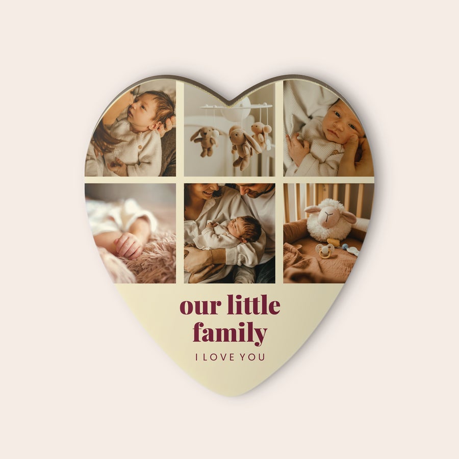 Personalized chocolate heart with six photos of a newborn baby and text "our little family I LOVE YOU" printed on the white chocolate surface.