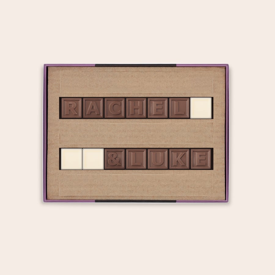 Personalized chocolate telegram in a brown box spells out RACHEL & LUKE in milk chocolate with white chocolate spaces