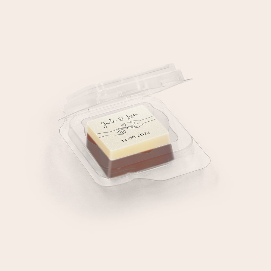Delicious chocolate favours with a custom photo or logo, showing a personalized treat with "Jade & Liam" and "12.06.2024" printed on white chocolate