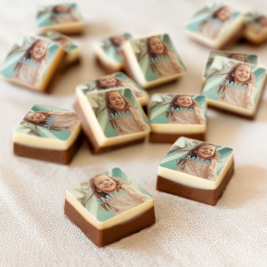 Personalised photo chocolates - Individually wrapped Delicious chocolate favors with a girl's photo and name "Emma" printed on top, arranged on a white surface.
