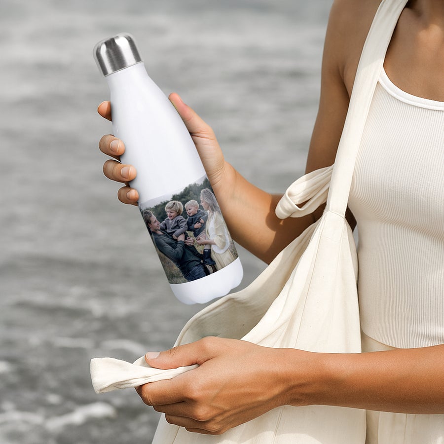 Personalised insulated water bottle A person holding a personalized insulated water bottle with a printed family photo