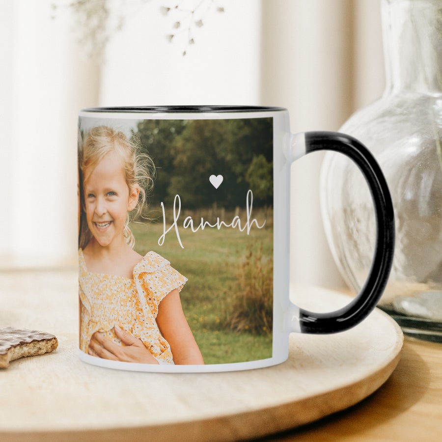 A personalized black and white coloured mug with a young girl and the name Hannah printed on it. Give a coloured mug as a gift!