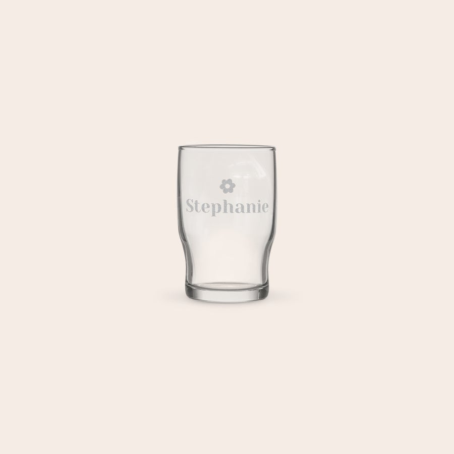 Personalized water glass engraved with the name Stephanie and a flower icon