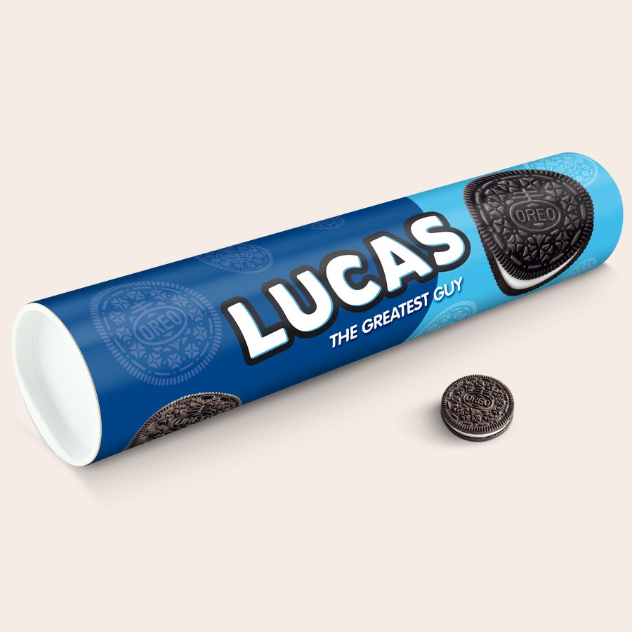 Personalized Mega Oreo Gift Tube with name Lucas and text The Greatest Guy printed on blue packaging, with one Oreo cookie next to it